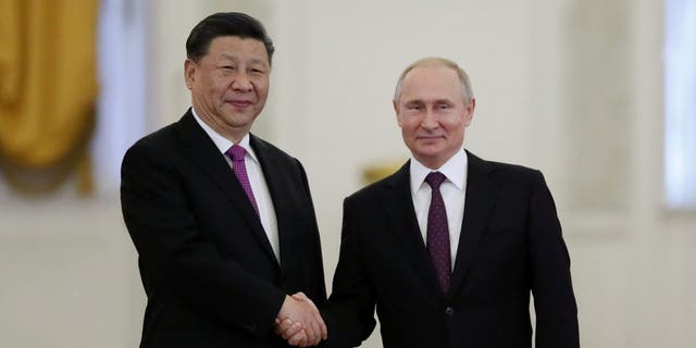 Russian President Vladimir Putin shakes hands with his Chinese counterpart Xi Jinping at the Kremlin in Moscow, Russia