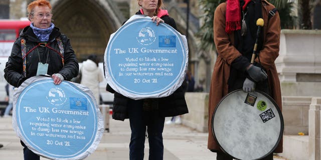 Activists protest the dumping of raw sewage in waterways, at Parliament Square on March 13, 2023, in London.