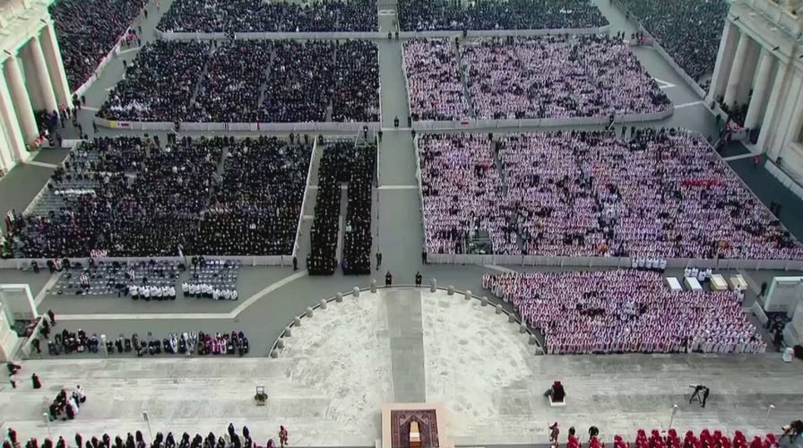Thousands of mourners sing during the funeral mass for Pope Benedict