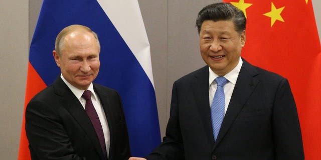 Russian President Vladimir Putin, left, signed an economic deal with Chinese President Xi Jinping during a bilateral meeting on Tuesday in Moscow.