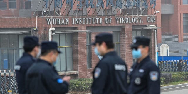 Security personnel stand guard outside the Wuhan Institute of Virology in Wuhan, China.