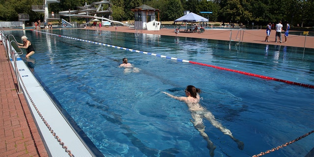 Swimmers do their laps in the pool at the Pankow summer pool in Germany, in August 2022. 