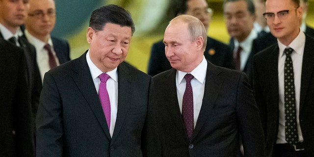FILE - Chinese President Xi Jinping, left, and Russian President Vladimir Putin enter a hall for talks in the Kremlin in Moscow, Russia, June 5, 2019. 