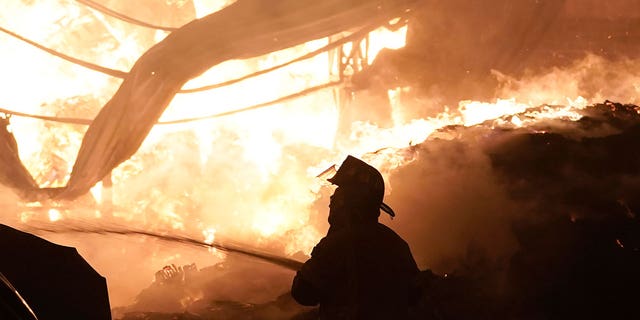 A firefighter works to extinguish a fire at the Central de Abasto wholesale market, the main food distribution center in Mexico City, on April 6, 2023. 