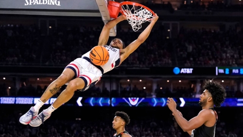 Connecticut guard Andre Jackson Jr. dunks the ball over Miami forward Norchad Omier, right, during their Final Four game.
