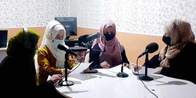 Najia Sorosh head of Sadai Banowan a women-run radio station, right, speaks with her Staff in the broadcasting studio in Badakhshan province, Afghanistan, on Mar. 7, 2023. 