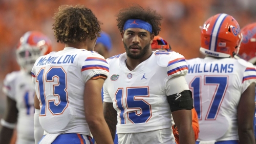 Anthony Richardson (15) talks with teammate Donovan McMillon during a game between the University of Tennessee Volunteers and the University of Florida Gators at Neyland Stadium.