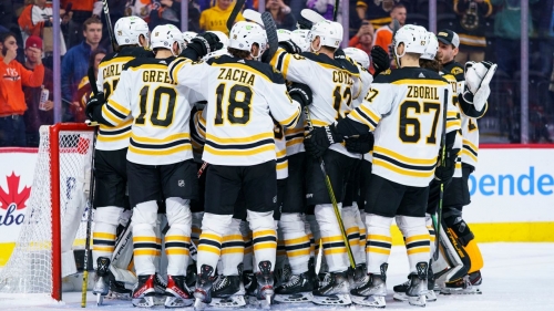 Boston Bruins gather around Jeremy Swayman as they celebrates their win against the Philadelphia Flyers on Sunday, April 9, 2023, in Philadelphia. 