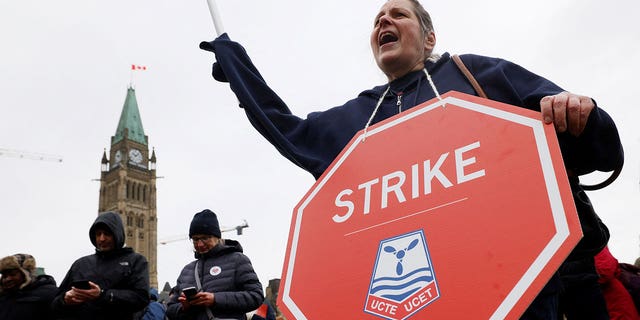 Protester with strike sign outside Canadian parliament