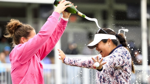 Vu is sprayed with champagne after winning.