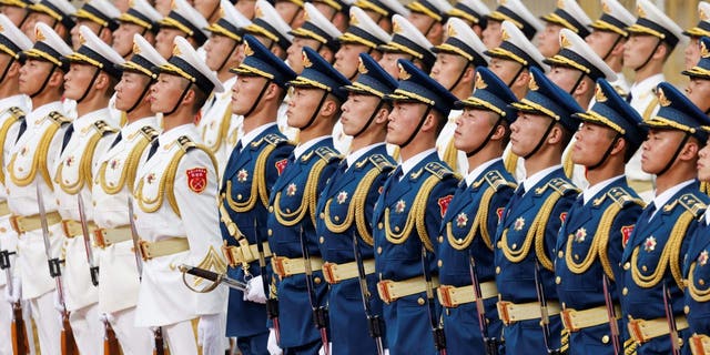 Chinese honor guard arrive for the welcoming ceremony for French President Emmanuel Macron and China's President Xi Jinping in Beijing on April 6, 2023.