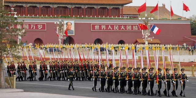 Chinese honor guard arrive for the welcoming ceremony for French President Emmanuel Macron and China's President Xi Jinping in Beijing on April 6, 2023.
