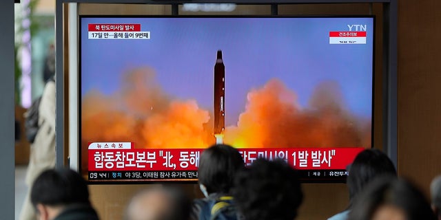 A TV screen is seen reporting North Korea's missile launch on Thursday, April 13, 2023, with file footage during a news program shown at the Seoul Railway Station in Seoul, South Korea.