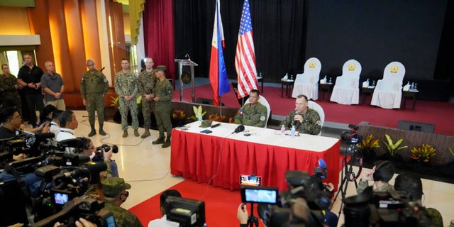 U.S. Marine Corps Major General Eric Austin, right, U.S. Exercise Director Representative, right, with Philippine Army Major General Marvin Licudin, Philippine Exercise Director, answers a question from a reporter after the opening ceremonies of a joint military exercise flag called "Balikatan," a Tagalog word for "shoulder-to-shoulder," at Camp Aguinaldo military headquarters on April 11, 2023, in Quezon City, Philippines. 