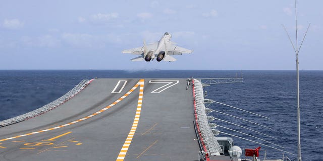 A J-15 Chinese fighter jet takes off from the Shandong aircraft carrier on April 9, 2023. China authorities issued a warning for possible rocket debris in waters northeast of Taiwan.