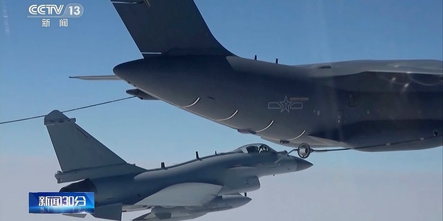 In this image taken from video footage run Saturday, April 8, 2023, by China's CCTV, a Chinese fighter jet performs a mid-air refueling maneuver at an unspecified location. 