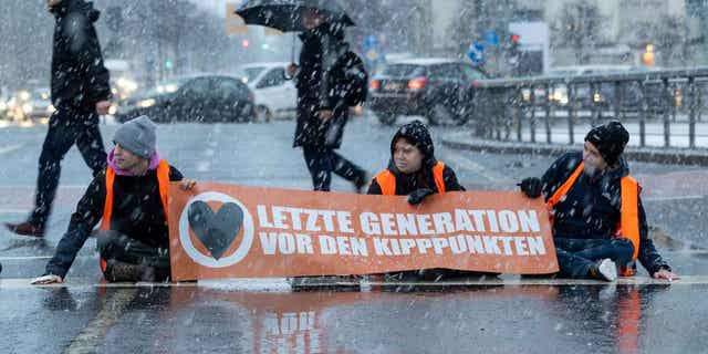 Activists of the "Last Generation" are pictured sitting on a street in Dresden, Germany, on Jan. 20, 2023. The group announced they will stage more protests in Berlin in an effort to force the government into doing more to curb global warming.