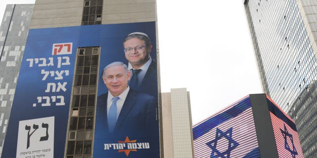 An election campaign poster for far-right Otzma Yehudit (Jewish Power), with images of party leader Itamar Ben-Gvir behind Prime Minister Benjamin Netanyahu, Likud Party leader, on Feb. 25, 2020, in Tel Aviv, Israel. (Artur Widak/NurPhoto via Getty Images)