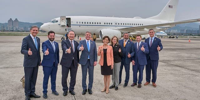 In this photo released by the Taiwan Presidential Office, Michael McCaul, chairman of the Foreign Affairs Committee in the United States House of Representatives, center left, and his wife Linda Mays McCaul, center right, gesture with Taiwan's deputy foreign minister Tah-ray Yui, third from left, and their delegations upon arrival in Taipei, Taiwan, Thursday, April 6, 2023.