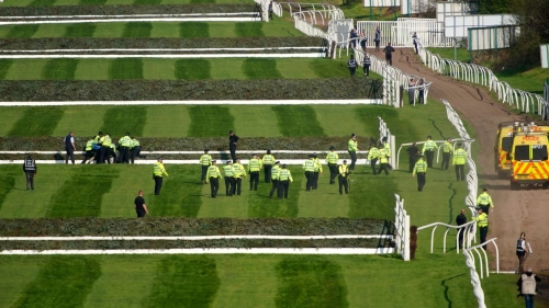 Police officers respond to protestors attempting to invade the race course ahead of the Grand National. 