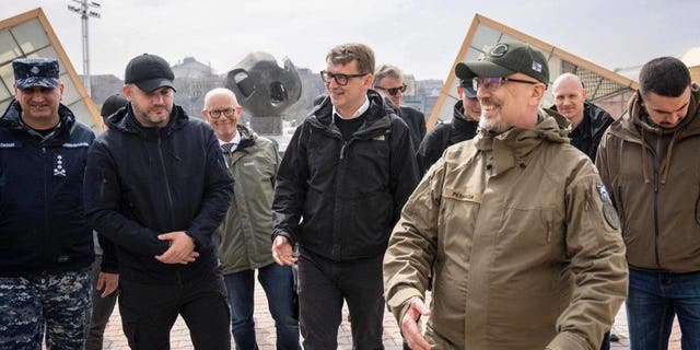 Ukrainian Defence Minister Oleksii Reznikov, right, and Danish Defense Minister Troels Lund Poulsen, center, visit the port in Odessa on April 11, 2023.
