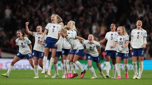 England's players celebrate winning the penalty shootout against Brazil.