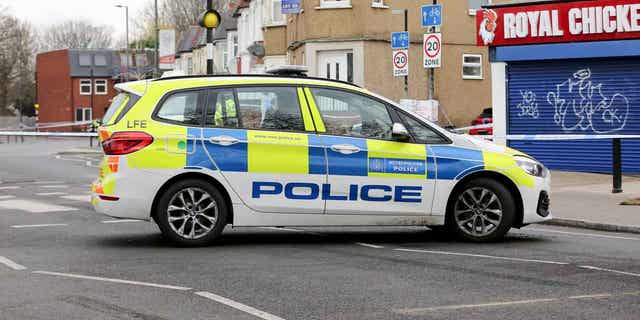 Police car outside a cordon on Arnold Road in Tottenham