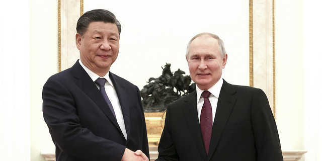Russian leader Vladimir Putin and Chinese President Xi Jinping shake hands before a meeting at the Kremlin in Moscow on March 20, 2023.