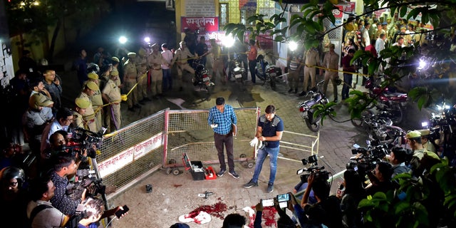 Police cordoned off the area where three assassins disguised as journalists gunned down a former Indian politician.