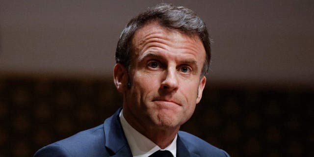 French President Emmanuel Macron looks on after delivering a speech at The Hague on April 11, 2023, as part of a state visit to the Netherlands.