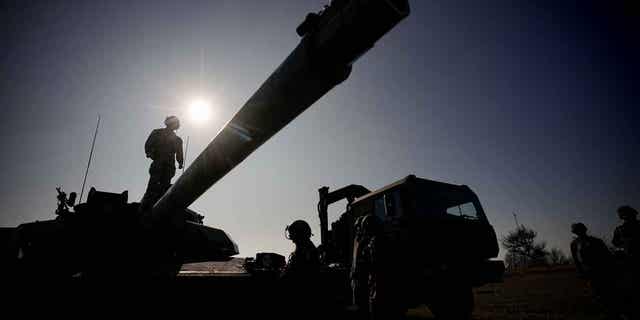 A French soldier stands on a battle tank at a firing range in Capu Midia, on the Black Sea shore, Romania, on Feb. 9, 2023. The French government approved on April 4, 2023, a budget bill presented as the biggest military spending effort for France since the 1960s.