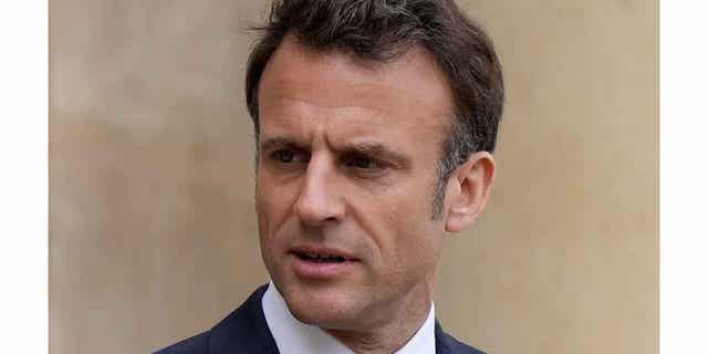 French President Emmanuel Macron looks on as he talks with Senegalese war veterans on April 14, 2023, at the Elysee Palace in Paris. Macron is set to have his first televised address to the nation on April 17, 2023, since he enacted pension reforms. 