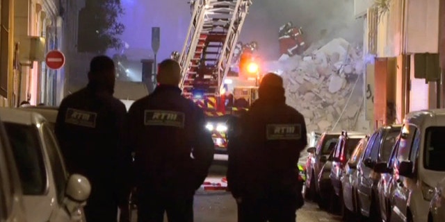 In this screengrab obtained from social media video, firefighters scoured the debris in search of victims trapped beneath the rubble.