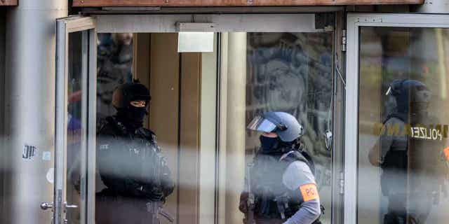 A police officer inspects a gym, the site of a stabbing attack, at a building in Duisburg, Germany, on April 18, 2023. Several people were severely injured in the stabbing attack.