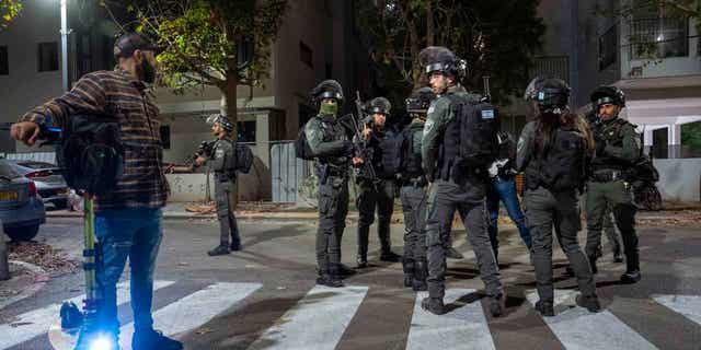 FILE- Israeli security forces search for a suspect in a shooting attack in Tel Aviv, Israel, Thursday, March 9, 2023. Israeli police said a Palestinian gunman shot and wounded three people in central Tel Aviv before the attacker was shot and killed. Police initially suspected there was a second attacker but later determined the gunman had acted alone. 