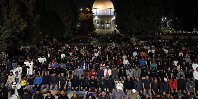 Palestinian worshippers perform "tarawih," an extra lengthy prayer held during the Muslim holy month of Ramadan, next to the Dome of Rock at the Al-Aqsa Mosque compound in the Old City of Jerusalem, Saturday, April 8, 2023.