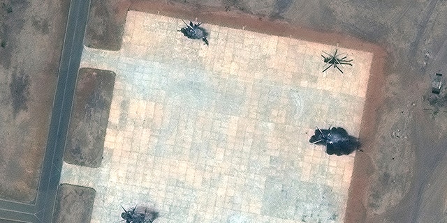 This satellite image provided by Maxar Technologies shows destroyed helicopters at a helicopter base in south Khartoum, Sudan, Tuesday, April 18, 2023. 