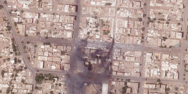 This satellite photo from Planet Labs PBC shows fires and destroyed market stalls in a commercial area of northern Khartoum, Sudan, Tuesday, April 18, 2023. 