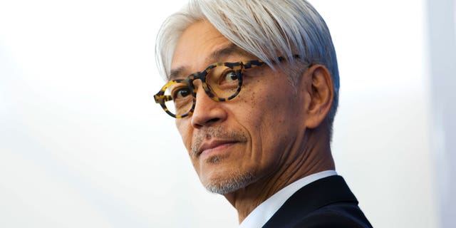Maestro Ryuichi Sakamoto poses during a photo call for the film "CODA" at the 74th Venice Film Festival in Venice, Italy, Sept. 3, 2017. Japan's recording company Avex says Sakamoto, a musician who scored for Hollywood movies such as "The Last Emperor" and "The Revenant," has died. He was 71. He died March 28, according to the statement released Sunday, April 2, 2023.