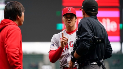 Los Angeles Angels starting pitcher Shohei Ohtani talks with home plate umpire Pat Hoberg after receiving a violation.