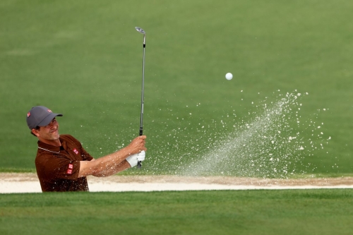 Adam Scott plays a bunker shot on the second hole Thursday.