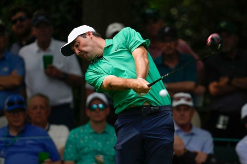 Defending Masters champion Scottie Scheffler hits his tee shot on the seventh hole Thursday.