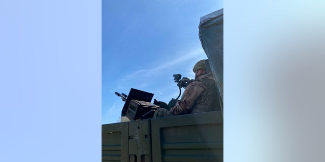 A member of Ukraine's 1st Presidential Brigade looking to the sky.