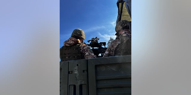 Ukrainian air defense members watch the skies to defend against Russian missile and drone attacks. 