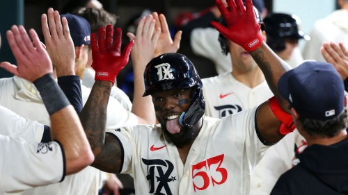 Adolis García celebrates in the dugout after his third home run of the night.