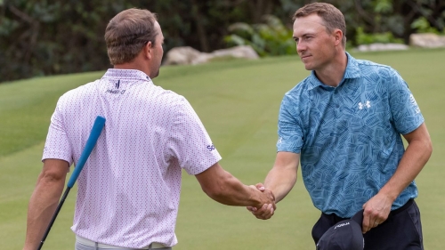 Spieth shakes hands with Montgomery after their round.