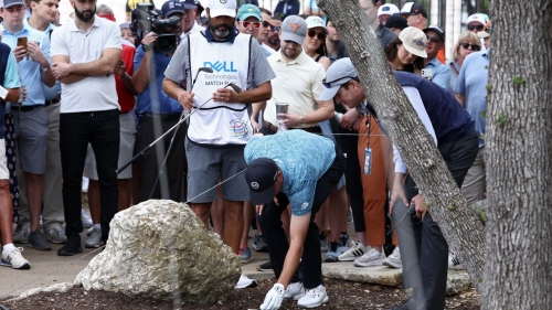 Spieth talks through his next move with a rules official.