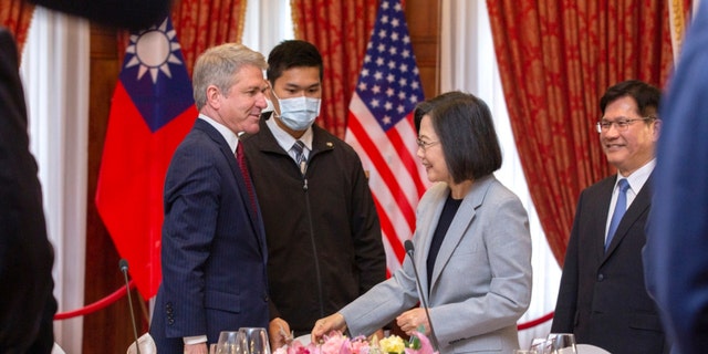 In this photo released by the Taiwan Presidential Office, House Foreign Affairs Committee Chairman Michael McCaul, R-Texas, left, and Taiwan's President Tsai Ing-wen, speak at a luncheon during a visit by a Congressional delegation to Taiwan in Taipei, Taiwan, Saturday, April 8, 2023. 