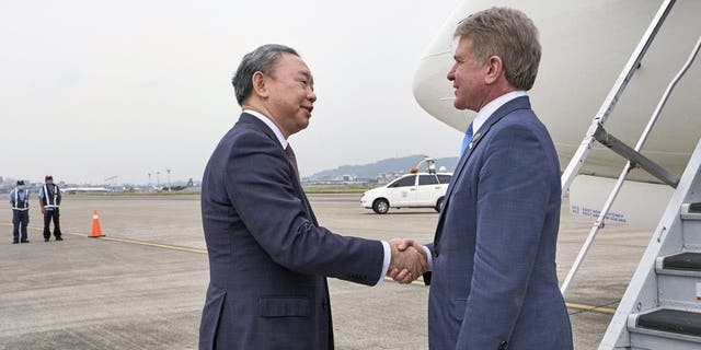 In this photo released by the Taiwan Presidential Office, Michael McCaul, chairman of the Foreign Affairs Committee in the United States House of Representatives, right, is welcomed by Taiwan's deputy foreign minister Tah-ray Yui upon arrival in Taipei, Taiwan, Thursday, April 6, 2023.