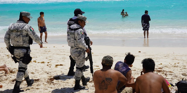 Mexican soldiers talk to spring breakers
